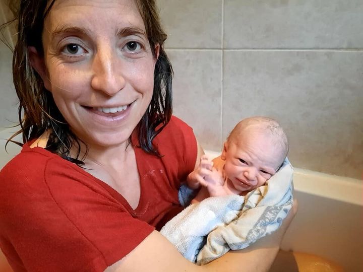 Corinne Card with her baby Freddie, shortly after giving birth in the bath.