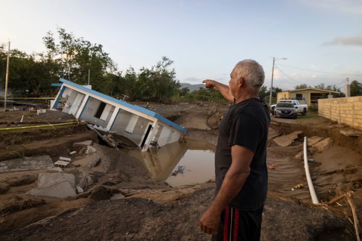 A man points to a house destroyed by Hurricane Fiona in Villa Esperanza, Salinas, Puerto Rico, Wednesday, Sept. 21, 2022.