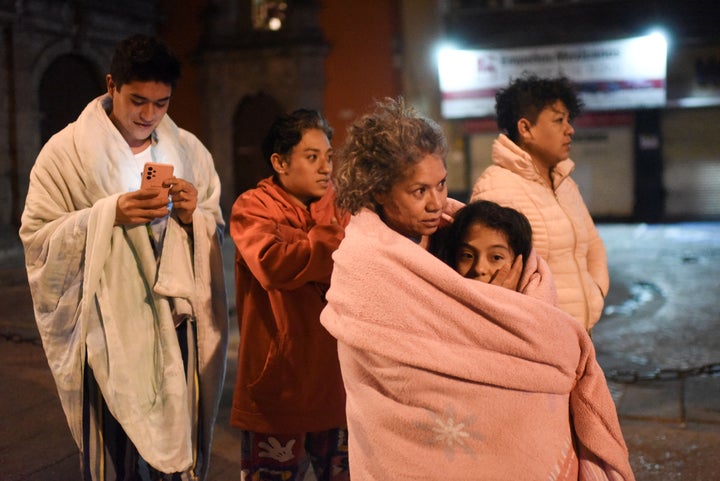 Residents stand in a street after a 6.8-magnitude earthquake hit Mexico City on Thursday.