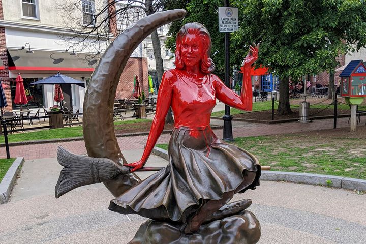 This image provided by Daniel Fury shows the "Bewitched" statue partially covered with red paint on June 6, 2022, in Salem, Mass. A man has plead guilty Tuesday, Sept. 20, 2022, to vandalizing the tourist favorite statue in Salem and will be sentenced to 18 months of probation for dousing the bronze statue with red paint earlier in the summer. (Daniel Fury/Black Cat Tours via AP, File)