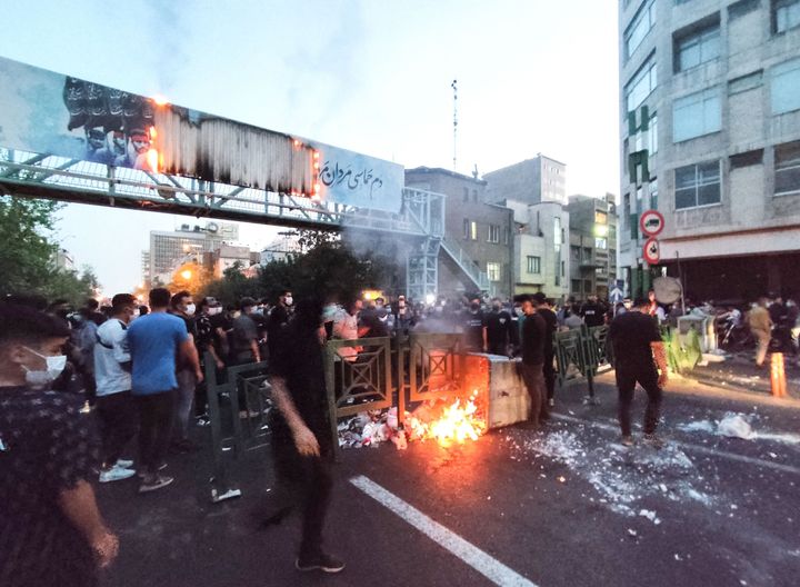 A photo taken by AFP outside Iran on Sept. 21, 2022 shows Iranian protesters burning a garbage can in the capital Tehran during a protest for Mahsa Amini, days after she died in police custody.  (Photo by AFP) (Photo by -/AFP via Getty Images)