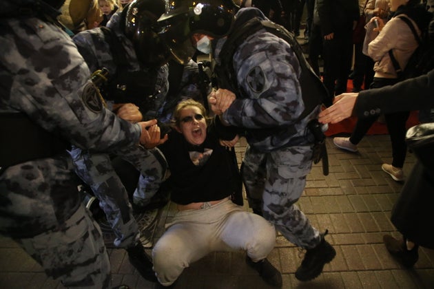 Russian police officers detain a protester during a protest rally at Arbat street in Moscow, Russia.