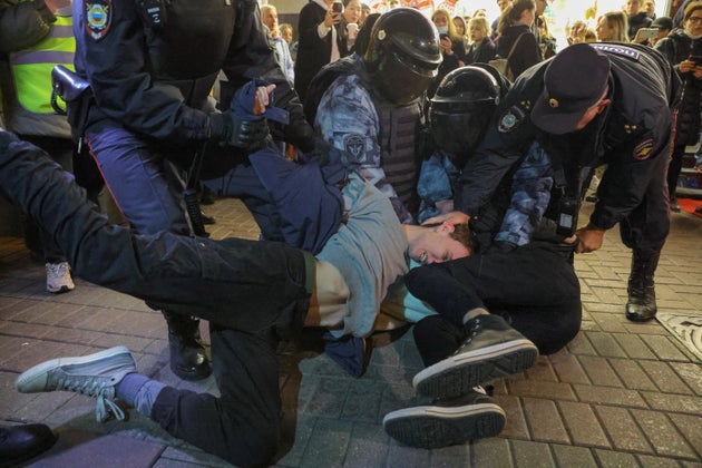 Russian law enforcement officers detain men during an unsanctioned rally in Moscow, after opposition activists called for street protests against the mobilisation of reservists ordered by Vladimir Putin.