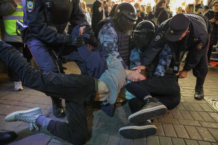 <strong>Russian law enforcement officers detain men during an unsanctioned rally in Moscow, after opposition activists called for street protests against the mobilisation of reservists ordered by Vladimir Putin.</strong>