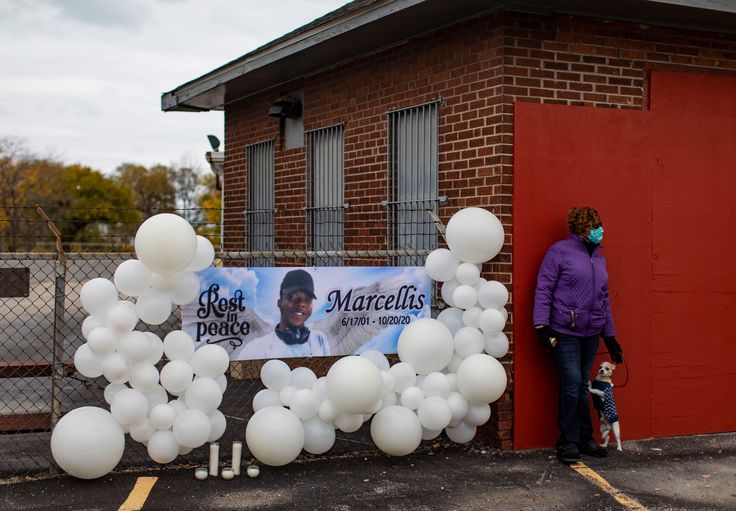 People gather before a prayer vigil for Marcellis Stinnette, 19, on Sunday, Oct. 25, 2020 at the corner of Helmholtz and MLK Jr. Drive in Waukegan. Stinnette was shot and killed by Waukegan police on Tuesday. (Brian Cassella/Chicago Tribune/TNS via Getty Images)