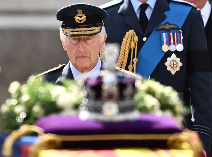 King Charles III walks down  the coffin of Queen Elizabeth II during a procession from Buckingham Palace to the Palace of Westminster connected  Sep. 14.