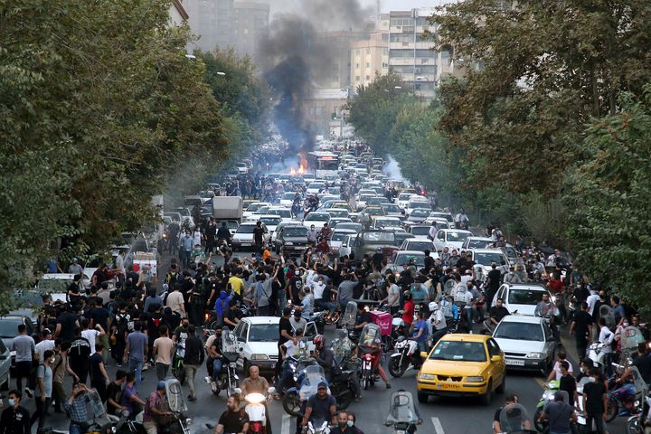 In this photo taken by an individual not employed by the Associated Press and obtained by the AP outside Iran, protesters chant slogans during a protest over the death of a woman who was detained by the morality police, in downtown Tehran, Iran, Wednesday, Sept. 21, 2022. (AP Photo)