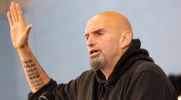 Tattooed dates of death can be seen on John Fetterman's arm as he campaigned for the Senate on Saturday in Pennsylvania.