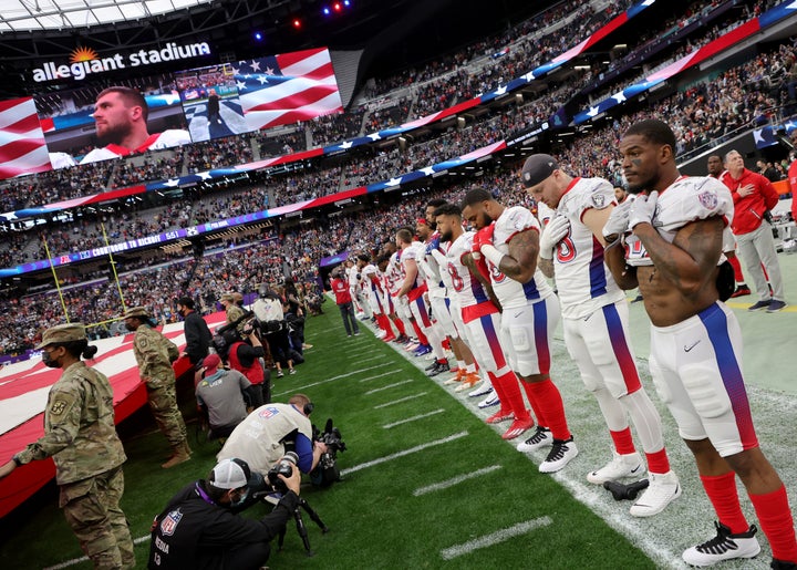 AFC players stand on the sideline as the national anthem is performed before the 2022 NFL Pro Bowl at Allegiant Stadium.