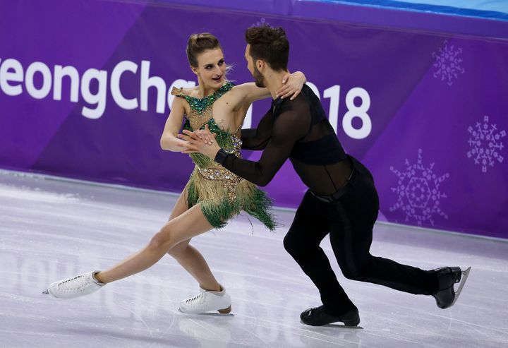 Gabriella Papadakis skating with partner Guillaume Cizeron while dealing with a wardrobe malfunction that exposed her chest during the 2018 PyeongChang Winter Olympic Games.
