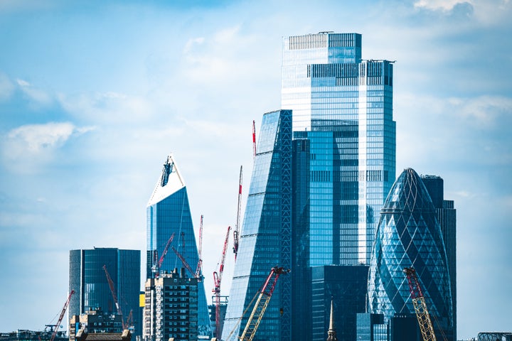 London City skyscrapers overlooking homes along River Thames
