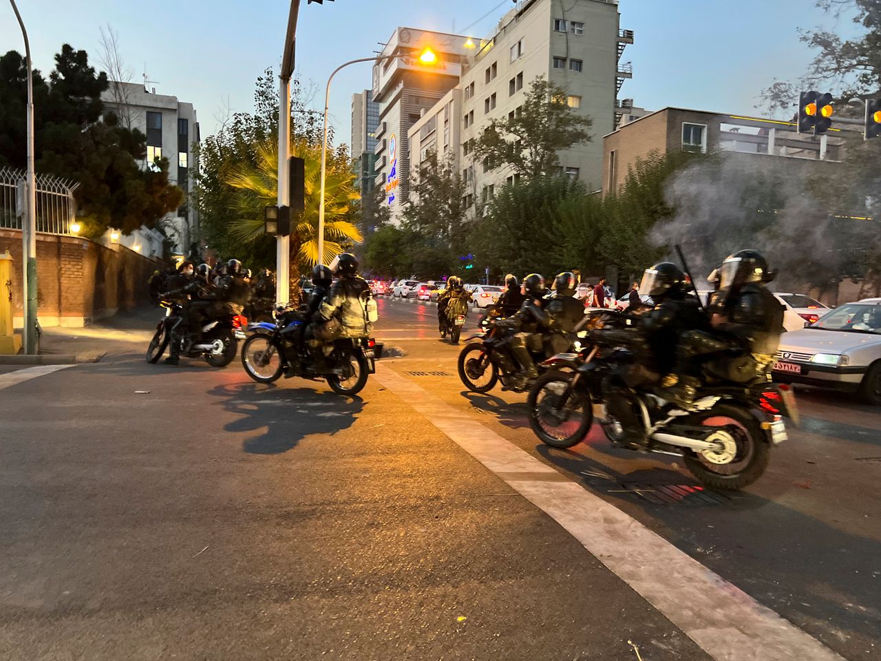 In this Monday, Sept. 19, photo taken by an individual not employed by The Associated Press and obtained by the AP outside Iran, anti-riot police arrive to disperse demonstrators during a protest over the death of a young woman who had been detained for violating the country's conservative dress code, in downtown Tehran.