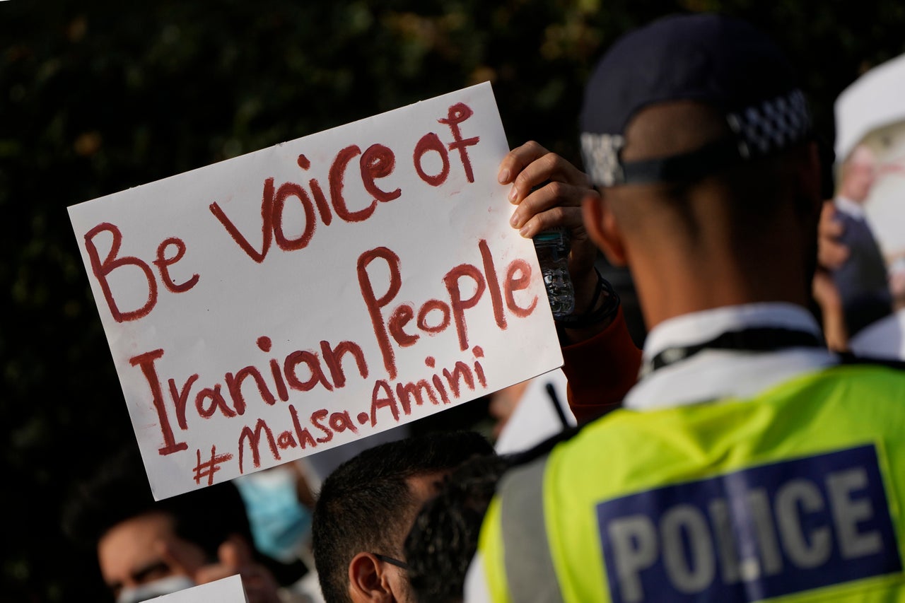 Demonstrators hold placards Sunday outside the Iranian Embassy in London to protest the death of Iranian Mahsa Amin.