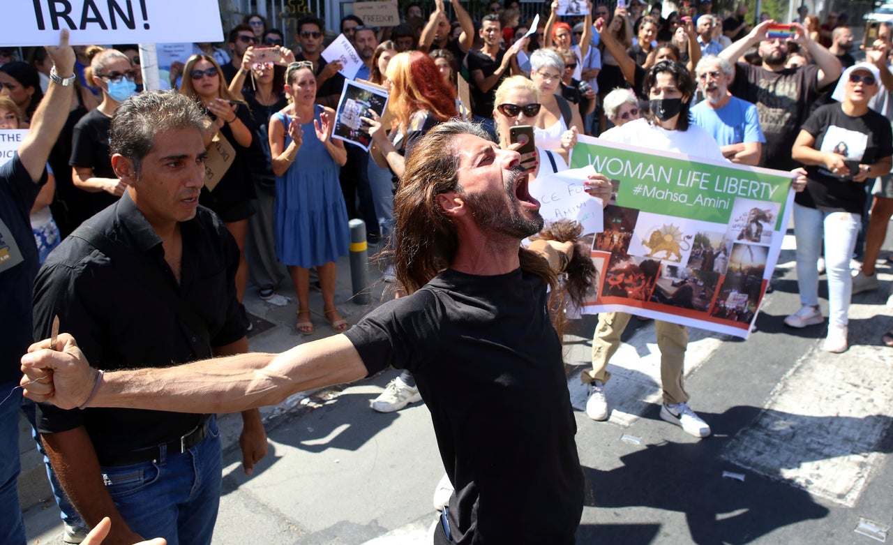 People shout slogans during a protest Sunday against the death of Iranian Mahsa Amini, outside the Iranian Embassy, in Nicosia, Cyprus.