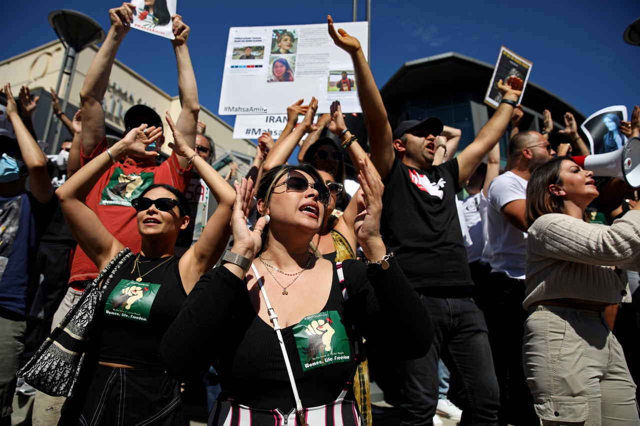 Hundreds of people gather in front of the Sherman Oaks Galleria in memory of Mahsa Amini, 22, who died in police custody after being arrested for violating Iran's hijab rules, on Sunday in Los Angeles.