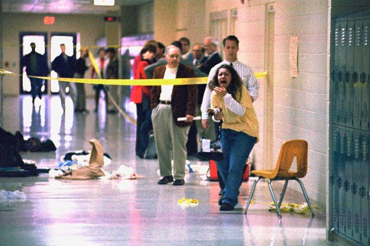 A Heath High School student screams at seeing the scene of a shooting at the school where fellow student Michael Carneal opened fire on Dec. 1, 1997.