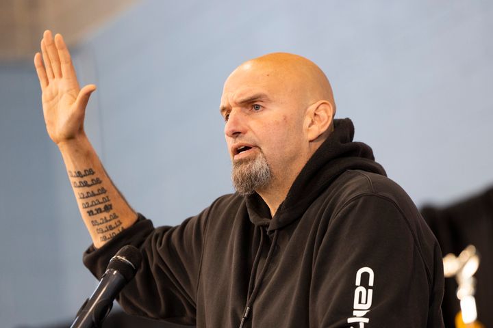 Pennsylvania Lt. Gov. John Fetterman (D) speaks in Philadelphia on Saturday. The tattoos on his left arm mark the dates of nine violent deaths that took place in Braddock during his mayoralty. He says he is proud of also presiding over a five-year period without any murders.