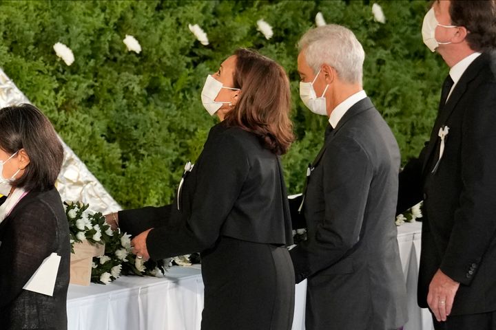 Vice President Kamala Harris, center left, and U.S. Ambassador to Japan Rahm Emanuel lay flowers during the state funeral for Japan's former prime minister Shinzo Abe in the Nippon Budokan in Tokyo on Sept. 27, 2022. 