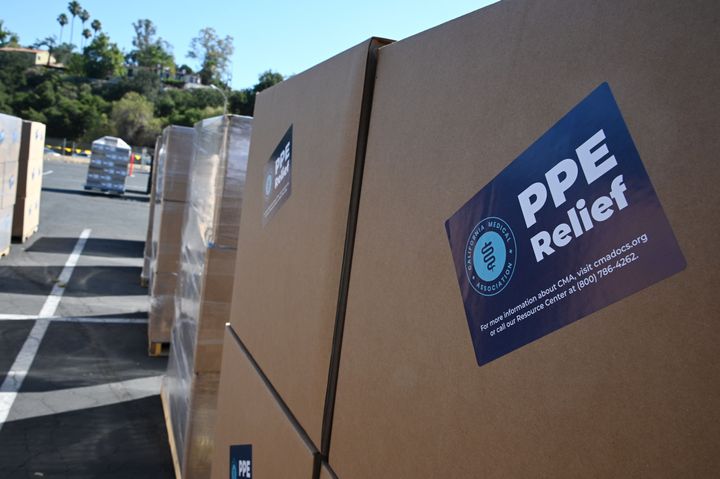 The CDC now says that health care workers no longer need to wear a mask indoors unless they are in areas of high virus transmission. Boxes full of medical-grade personal protective equipment are seen at a distribution center in Pasadena, California.