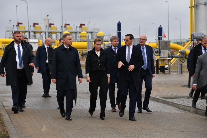 Denmark's Prime Minister Mette Frederiksen (C) is flanked by Poland's Prime Minister Mateusz Morawiecki (C-R) and Poland's President Andrzej Duda (C-L) as they walk over the grounds of the Baltic Pipe gas pipeline during it's opening ceremony in Budno near Goleniow, Poland