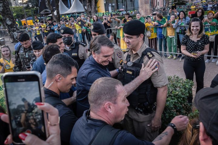 Brazilian President Jair Bolsonaro salutes a policeman during a campaign rally at Praça da Liberdade in Belo Horizonte in Minas Gerais State on Aug. 24.