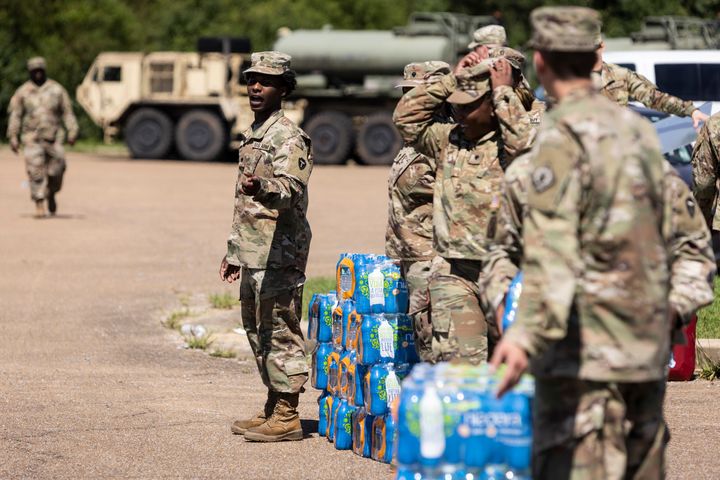 Members of the Mississippi National Guard hand out bottled water at a school in Jackson on Sept. 1 in response to the water crisis.