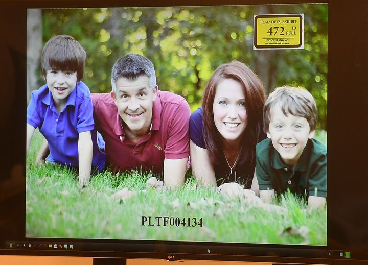 A photo of Ian and Nicole Hockley, and their sons Dylan (left) and Jake, is displayed for the jury panel during the Hockley's testimony in the Alex Jones defamation trial at Superior Court in Waterbury, Connecticut, on Tuesday.