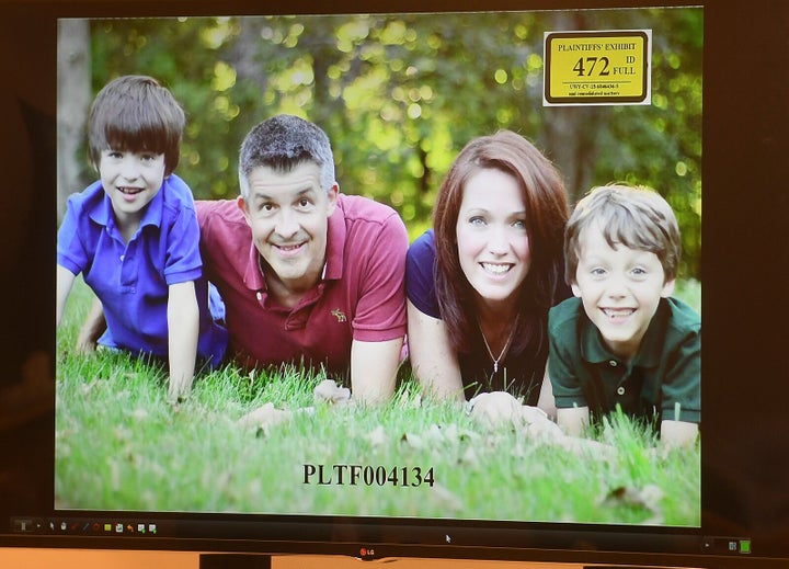 A photo of Ian and Nicole Hockley, and their sons Dylan (left) and Jake, is displayed for the jury panel during the Hockley's testimony in the Alex Jones defamation trial at Superior Court in Waterbury, Connecticut, on Tuesday.