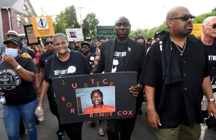 Doreen Coleman, mother of Richard "Randy" Cox Jr., walks with civil rights attorney Benjamin Crump (middle) and attorney Michael Jefferson during a march for Justice for Randy Cox in New Haven, Connecticut, on July 8, 2022.