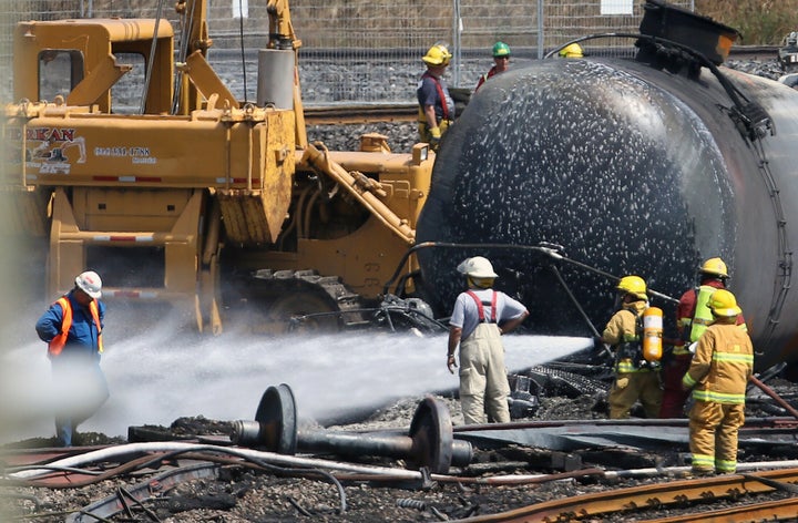 Firefighters spray wagons at the site of the train wreck in Lac-Megantic July 14, 2013. 