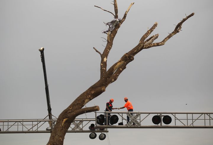 Kansas City Southern workers repair a broken railroad signal after a massive tornado passed through the town killing at least 123 people on May 25, 2011, in Joplin, Missouri.