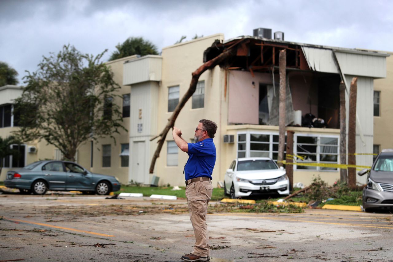 David Dellinger of the National Weather Service surveys the damage from the tornado spawned from Hurricane Ian in Delray Beach on Wednesday.