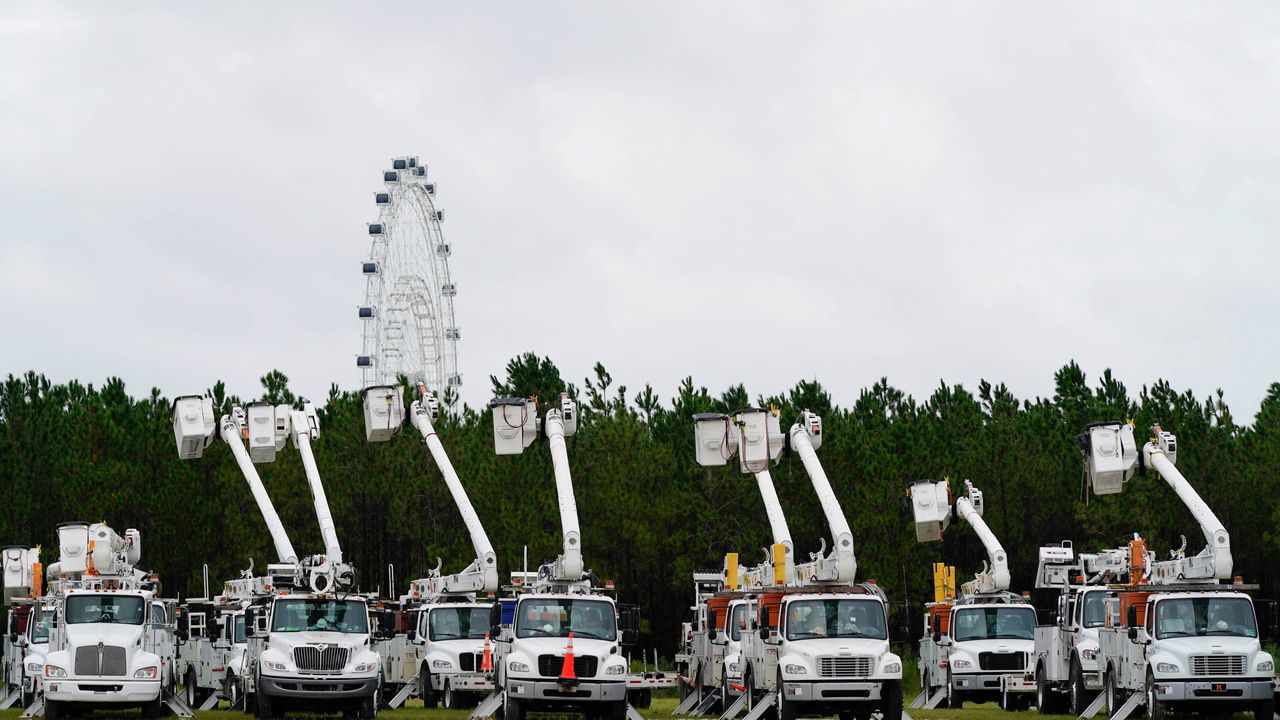 Utility trucks are staged near the Orange County Convention Center ahead of Hurricane Ian on Wednesday in Orlando.