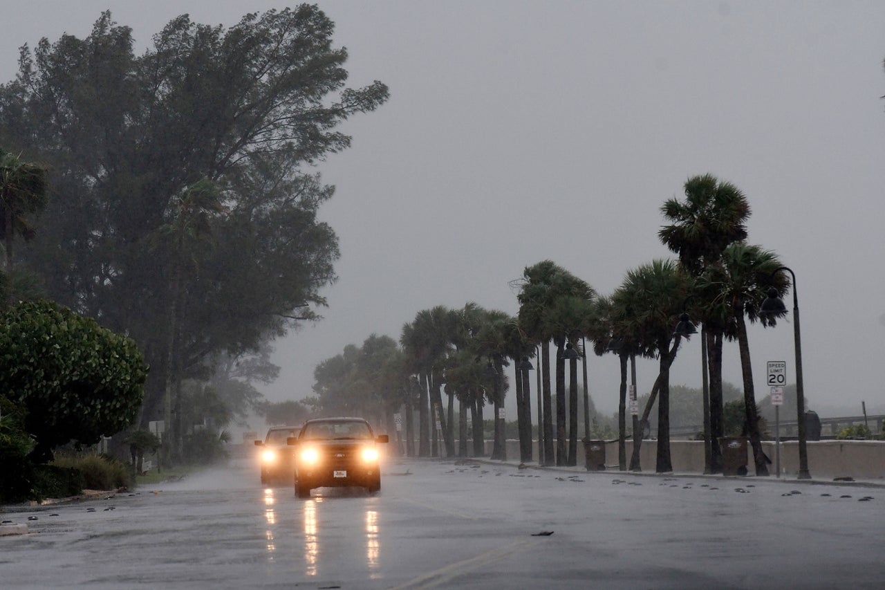 Local residents drive near the bay of St. Pete Beach as the winds from Hurricane Ian arrive on Wednesday.