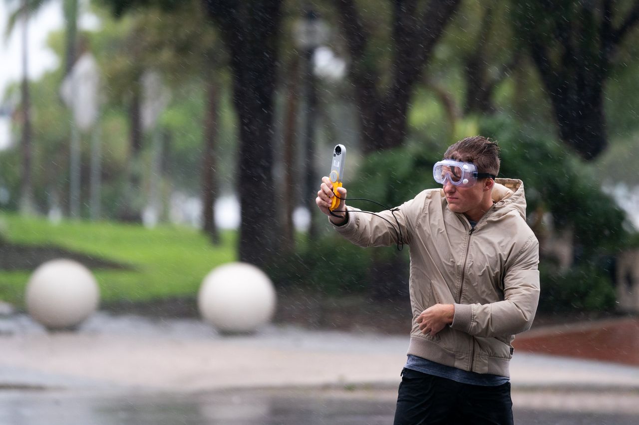 Jacob Woods, a meteorology student at the Mississippi State University, measures wind gusts as Hurricane Ian approaches Wednesday in Sarasota.