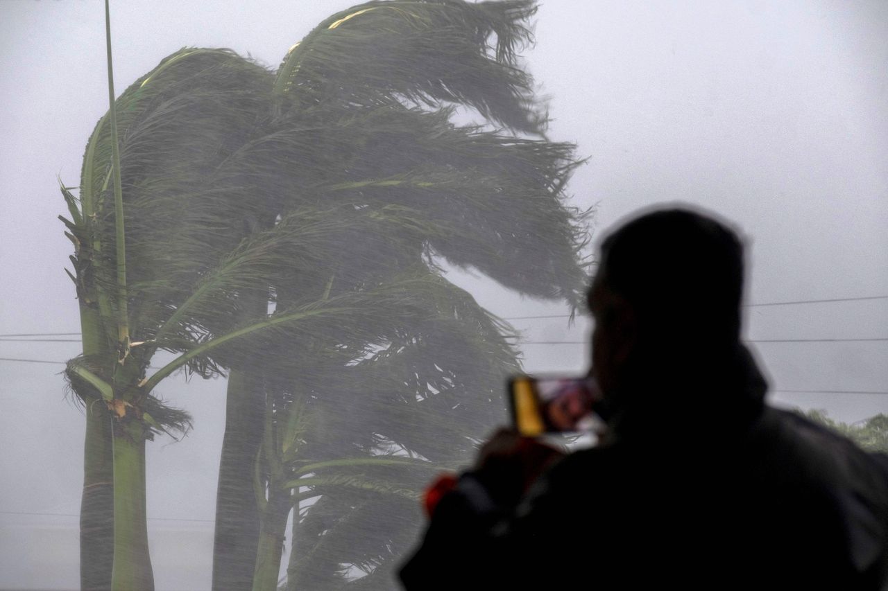 A man livestreams as gusts from Hurricane Ian hit Punta Gorda on Wednesday.