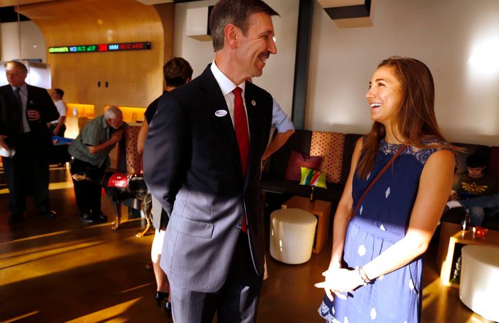 Tulsa District Attorney candidate Steve Kunzweiler, left, chats with his daughter Jennifer Kunzweiler during his watch party in the Republican runoff election on Aug. 26, 2014, in Tulsa, Okla. Kunzweiler was recovering Wednesday, Sept. 28, 2022, at his home in Tulsa, one day after police said he was stabbed by his adult daughter. Jennifer Kunzweiler, 30, was arrested following the stabbing at his home, according to a social media post Tuesday night by Tulsa Police Chief Wendell Franklin. (James Gibbard/Tulsa World via AP)