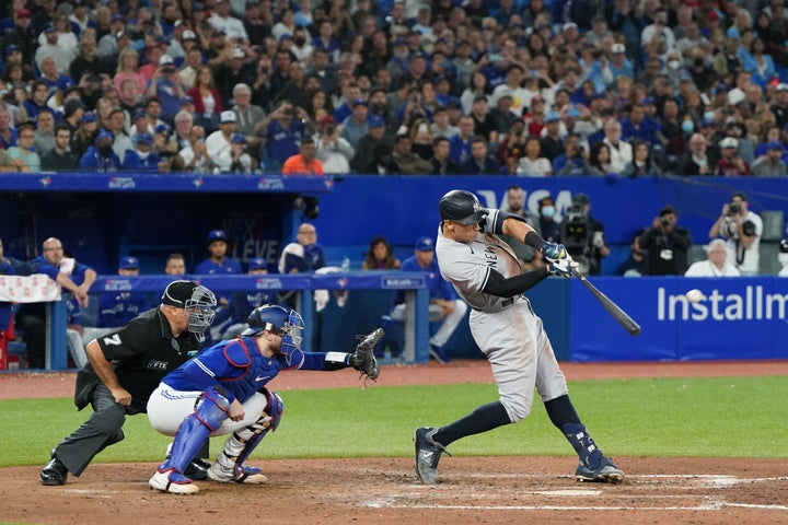 New York Yankees slugger Aaron Judge hits a home run Wednesday in the seventh inning to tie Roger Maris' American League record for most home runs in a single season, at 61, during the game against the Blue Jays in Toronto.