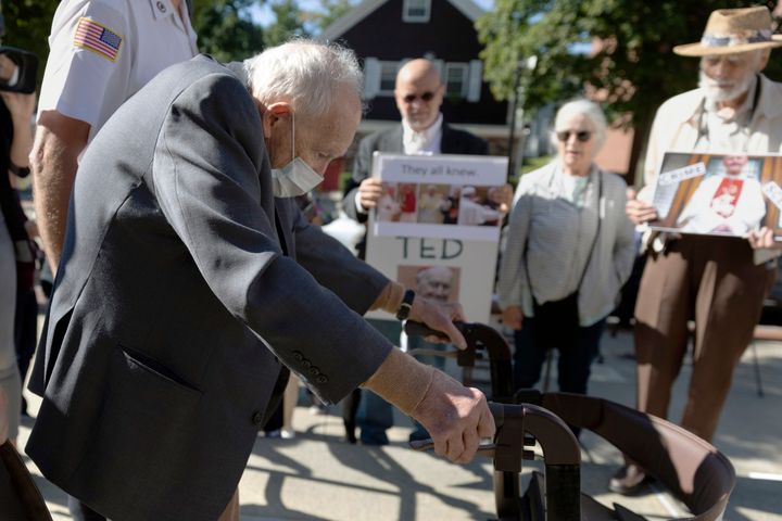 FILE - Demonstrators watch as former Cardinal Theodore McCarrick leaves Dedham District Court after his arraignment, Friday, Sept. 3, 2021, in Dedham, Mass. McCarrick has pleaded not guilty to sexually assaulting a 16-year-old boy during a wedding reception in Massachusetts nearly 50 years ago.
