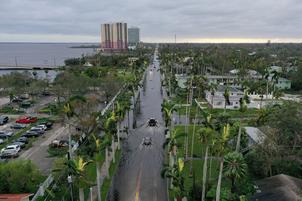 In this aerial view, vehicles make their way through a flooded area after Hurricane Ian passed through the area on Thursday in Fort Myers, Florida. 