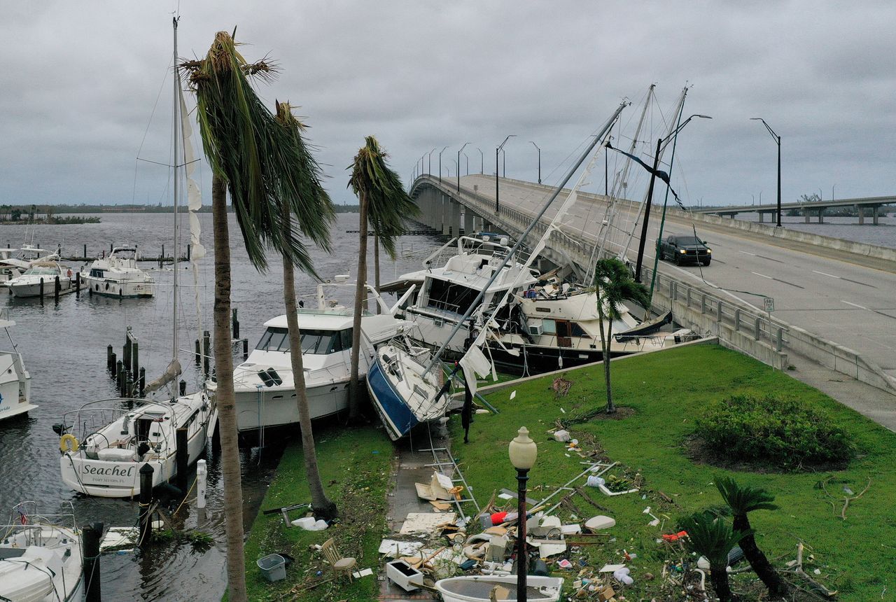 Boats are pushed up on a causeway after Hurricane Ian passed through the area on Thursday in Fort Myers.
