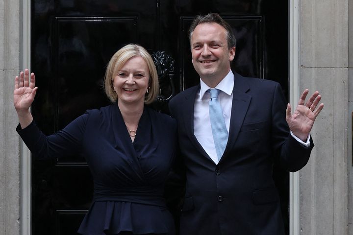 Outside No.10, Liz Truss poses with her husband Hugh O'Leary after delivering her first speech as Prime Minister.