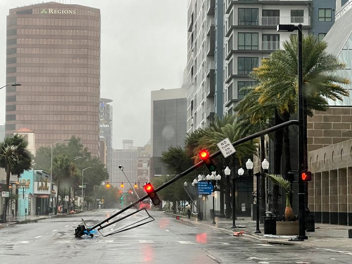 A stoplight pole is seen lying in the street after blown down by Ian's winds in downtown Orlando on Thursday.