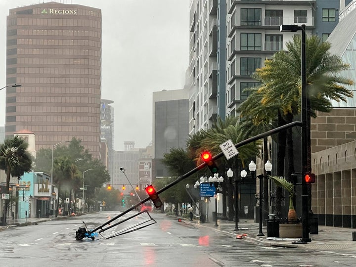 A stoplight pole is seen lying in the street after blown down by Ian's winds in downtown Orlando on Thursday.