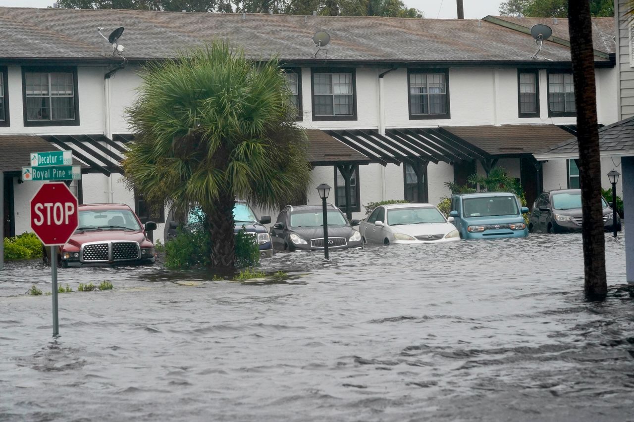 Vehicles sit in floodwater at the Palm Isle apartments in the aftermath of Hurricane Ian on Thursday in Orlando.