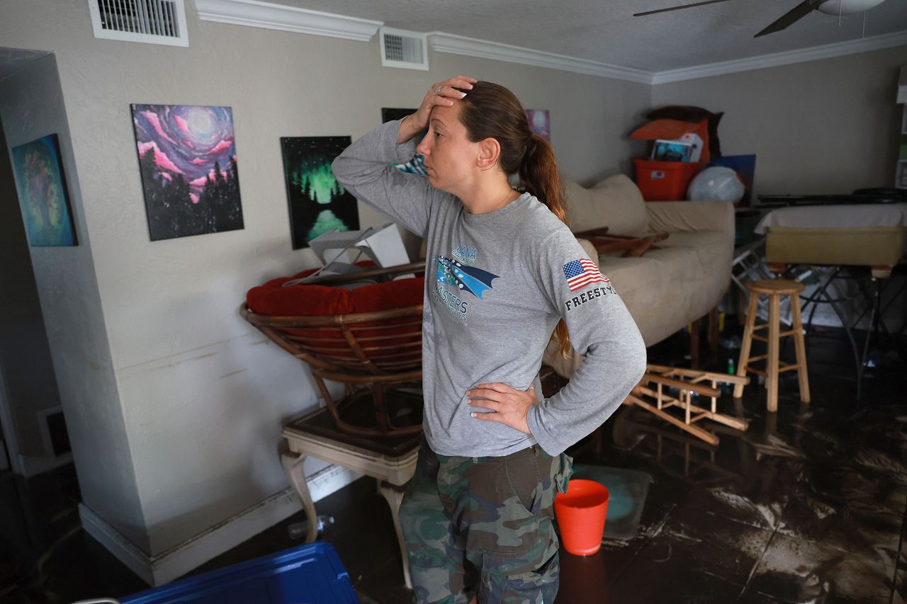 Stefanie Karas stands in her apartment after floodwater inundated it when Hurricane Ian passed through the area on Thursday in Fort Myers. 
