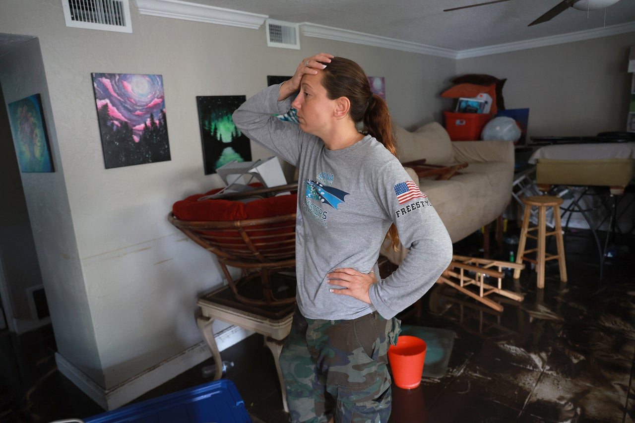 Stefanie Karas stands in her apartment after water flooded it as Hurricane Ian passed through the area Thursday in Fort Myers.