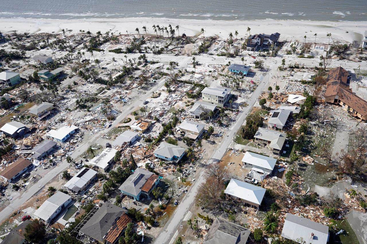 This aerial photo shows damaged homes and debris in the aftermath of Hurricane Ian, Thursday, Sept. 29, in Fort Myers.