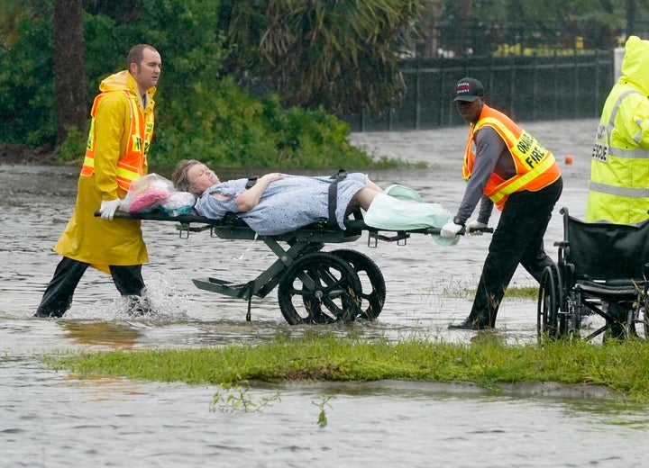 Authorities transport a person out of the Avante nursing home in the aftermath of Hurricane Ian, Thursday, Sept. 29, 2022, in Orlando, Fla. Hurricane Ian carved a path of destruction across Florida, trapping people in flooded homes, cutting off the only bridge to a barrier island, destroying a historic waterfront pier and knocking out power to 2.5 million people as it dumped rain over a huge area on Thursday. (AP Photo/John Raoux)