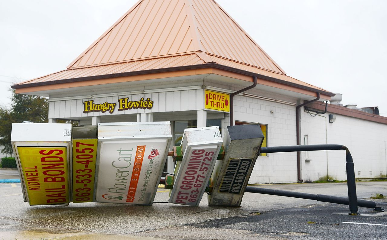 A commercial sign lies in the street after being toppled by the winds and rain from Hurricane Ian on Thursday in Bartow.